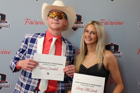 Winners Tyson C. and Lacey M. hold their certificates