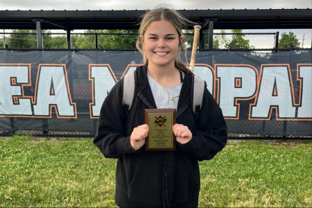  Softball player holding plaque from award